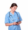 Charming nurse smiling while sending a text Royalty Free Stock Photo