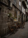 Charming old vintage historic brick stone house facade wall with wooden chair and table in Tui Pontevedra Galicia Spain