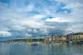 Charming panorama view of boats floating in Geneva lake buildings on clouds blue sky background