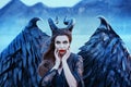 Charming portrait of dark angel with sharp horns and claws on strong powerful wings, wicked witch in black lace dress