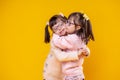 Charming positive sisters with chromosome abnormality hugging each other