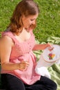 Charming pregnant woman in park