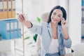 Charming, pretty woman shooting self picture on smart phone, holding eyelet of glasses on her face with fingers, posing for photo Royalty Free Stock Photo