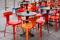 Charming red and orange chairs on cafe outdoor restaurant cafe and steel tables colorful terrace Royalty Free Stock Photo