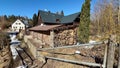 Charming Scenic Rustic House Nestled Amidst a Wood Pile Against a Clear Blue Sky Above