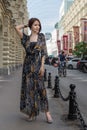 Charming sensual woman in fashionable gauzy clothing at a street