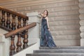 Charming sensual young woman in gauzy lengthy dress on stairs Royalty Free Stock Photo