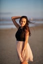 Attractive young woman walking on a natural background. Stylish feminine girl. Natural beauty concept.