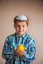 Charming seven year old boy in knitted kippah