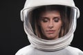 Charming skilled female cosmonaut is posing thoughtfully