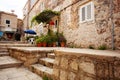 Charming small home with white front door and summer garden containers filled with annual flowers