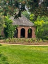 Small brick building with doorway arches at garden