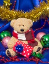 Charming small teddy bear with Christmas gift Royalty Free Stock Photo