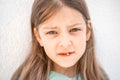 Charming smiling little girl kid with opened mouth shows staggering loose falling out first baby milk front tooth Royalty Free Stock Photo