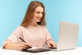 Charming smiling woman, creative designer using graphic tablet and typing keyboard laptop, working Royalty Free Stock Photo
