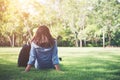 Charming smiling young hipster woman lying on green grass. Royalty Free Stock Photo