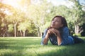 Charming smiling young hipster woman lying on green grass. Royalty Free Stock Photo