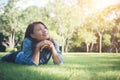 Charming smiling young hipster woman lying on green grass. Royalty Free Stock Photo