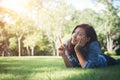 Charming smiling young hipster woman lying on green grass. Royalty Free Stock Photo