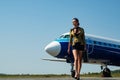 Charming stewardess dressed in blue uniform. Beautiful stewardess. Traveling and jet plane flying concept. Journey and Royalty Free Stock Photo