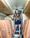 Charming stewardess dressed in blue uniform. Traveling and jet plane flying. Attendant and airhostess. Beautiful air Royalty Free Stock Photo