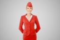 Charming Stewardess Dressed In Red Uniform On Gray Background. Royalty Free Stock Photo