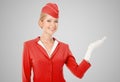 Charming Stewardess Dressed In Red Uniform Holding In Hand Royalty Free Stock Photo