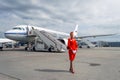 Charming Stewardess Dressed In Red Uniform. Russia, Saint-Petersburg. August 10, 2017.