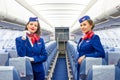 Charming Stewardess Dressed In Uniform in the passenger cabin of the aircraft. Russia, Saint-Petersburg. 23 November, 2017. Royalty Free Stock Photo