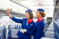 Charming Stewardess Dressed In Uniform in the passenger cabin of the aircraft. Russia, Saint-Petersburg. 23 November, 2017.