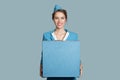 charming stewardess holding blue box luggage in hands