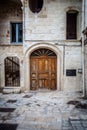 Charming Italian Balconies: Old Buildings Adorned Old Wooden Door in a Typical Polignano a Mare Street Royalty Free Stock Photo