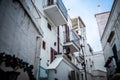 Charming Italian Balconies: White Buildings Adorned with Balconies in a Typical Polignano a Mare Street Royalty Free Stock Photo