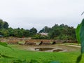 Charming stone bridge over a serene garden pond in Dehradun City, India. Scenic outdoor setting Royalty Free Stock Photo