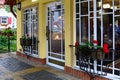 Charming and stylish entrance to small business decorated with flower pots