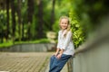 Charming stylish fashionable girl in park. Little child enjoy walk in park. Weekend walk. Kid walking. Summer holidays Royalty Free Stock Photo