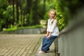 Charming stylish fashionable girl in park. Little child enjoy walk in park. Weekend walk. Kid walking. Summer holidays Royalty Free Stock Photo