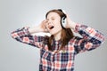 Charming teenage girl listening to music and singing