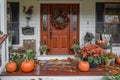 A charming Thanksgiving themed front porch with pumpkins, wreaths, and seasonal flowers Royalty Free Stock Photo