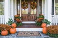 A charming Thanksgiving themed front porch with pumpkins, wreaths, and seasonal flowers Royalty Free Stock Photo