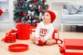 Charming toddler boy holds christmas gift box. Concept of Christmas holidays.