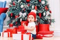 Toddler boy weared in festive clothes playing with christmas gift box. Concept of Christmas and New Year holidays. Royalty Free Stock Photo
