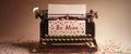 A charming vintage typewriter features a sheet of paper displaying the words Be Mine, enveloped by playful heart