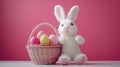 A charming white bunny sits on a table beside a colorful basket filled with beautifully decorated Easter eggs Royalty Free Stock Photo