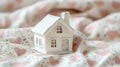 Charming White Miniature House on Heart-Patterned Fabric Royalty Free Stock Photo