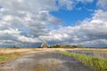 Charming windmill bu river and cblue sky with clouds