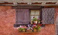 Charming Window in Eguisheim, France, with Shutters and Geranium Flowers Royalty Free Stock Photo