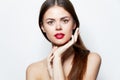Charming woman Bare shoulders hands near Faces red lips attractive look bright makeup