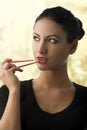 Charming woman with chopstick Royalty Free Stock Photo