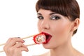 Charming woman eating roll with red caviar Royalty Free Stock Photo